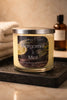 Phoenix Crafted Bergamot & Mint candle — pale yellow wax in clear glass jar with silver lid and black label, set on a wet black tray.