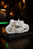 Pearl-white sculpted motorcycle candle with skull rider and hand-painted silver accents on slate base — Cedarwood Rider by Phoenix Crafted
