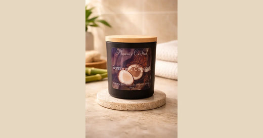 Phoenix Crafted bamboo coconut candle in a creamy tropical landscape composition.