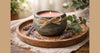 Phoenix Crafted gourmand fragrance candle in a warm dessert-inspired landscape composition.