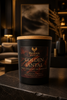 Golden Santal candle with mandarin, cedar, amber, and sandalwood styling for a Phoenix Crafted home-fragrance layering guide.