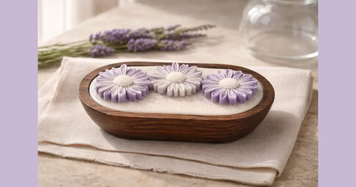 Phoenix Crafted lavender candle styled with lavender flowers in a calming landscape composition.