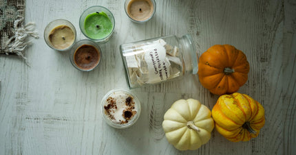 Autumn candle scene with warm seasonal accents for a fall fragrance guide.