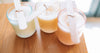 best homemade soy candles 2026 colorful hand-poured candles on a wooden table with wooden wicks