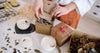 Candle, packaging, and natural materials arranged for a sustainability-claims guide.