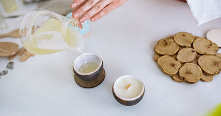 A person pouring wax into a handmade soy candle, highlighting the process of making the best handmade soy candles 2026.