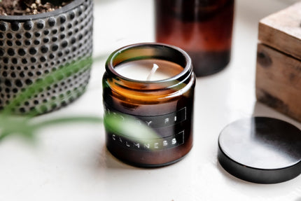 luxury sustainable handcrafted candles 2026 in stylish amber jar with lid, showcasing natural wax and calming scent.