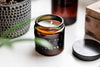 luxury sustainable handcrafted candles 2026 in stylish amber jar with lid, showcasing natural wax and calming scent.