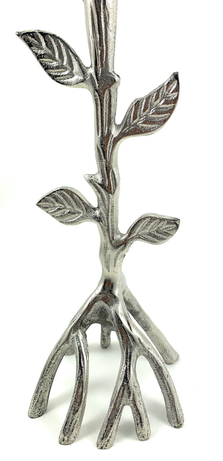 Silver-toned tree-branch candle holder with raised leaf details and a sculptural root-like base.