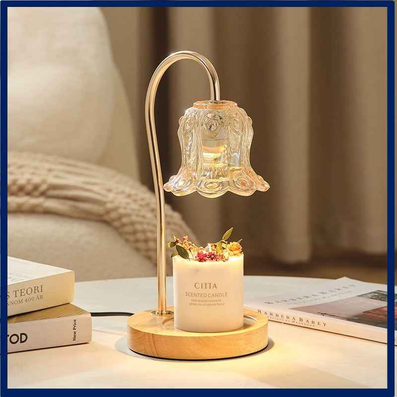 Lily of the Valley solid wood candle warmer lamp illuminating a scented candle on a stylish table.