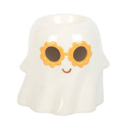 Glossy white ceramic ghost-shaped wax warmer with orange flower-shaped sunglasses, black lenses and small brown smile, hollow top opening.