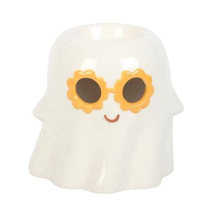 Glossy white ceramic ghost-shaped wax warmer with orange flower-shaped sunglasses, black lenses and small brown smile, hollow top opening.