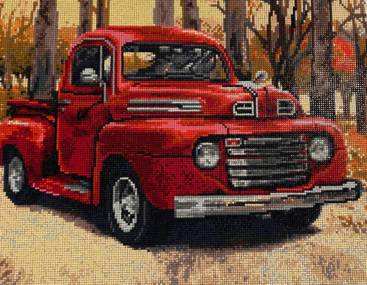 Autumn Haul Diamond Painting of a vintage red truck in a fall scene surrounded by trees and autumn colors.