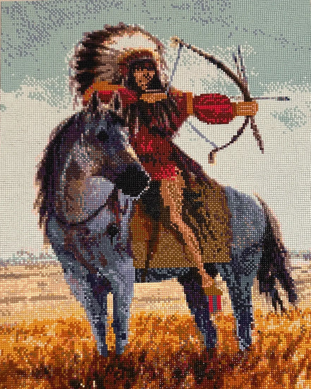 Diamond-painting close-up of a rider in a feathered headdress drawing a bow atop a gray horse, pale blue sky and golden grass