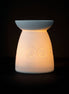 White Ceramic Seven Chakra Tealight Wax Warmer lighting up with chakra designs.