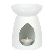 White ceramic tea-light wax warmer with shallow bowl top, teardrop front opening revealing a lit metal tealight and small flame.