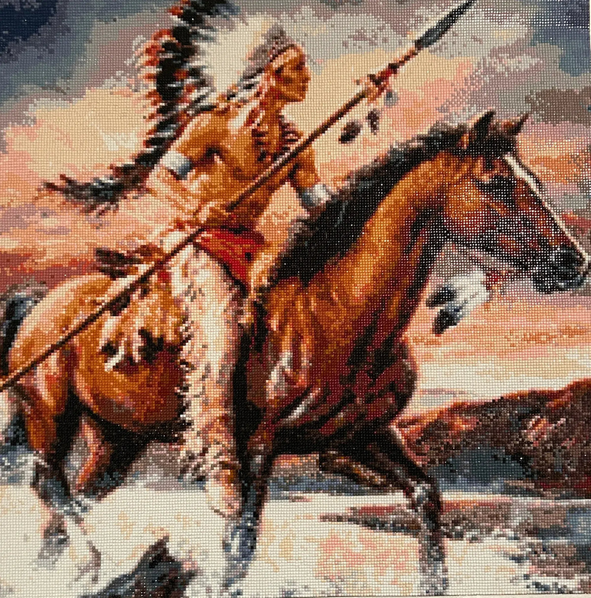 Close-up diamond painting of a rider wearing a feathered headdress and armbands.