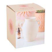 Elegant vase shaped oil burner and wax warmer in white packaging with decorative design.