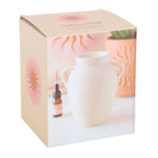 Elegant vase shaped oil burner and wax warmer in white packaging with decorative design.