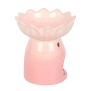 Glossy light-pink ceramic wax warmer with scalloped water-lily bowl atop a rounded hollow base featuring circular cutouts.