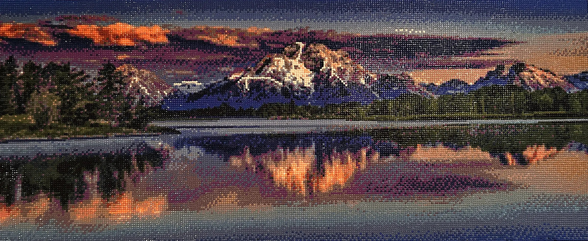 Sunset over Still Waters Diamond Painting featuring vibrant sunset skies and snow-capped mountains reflecting on the lake.