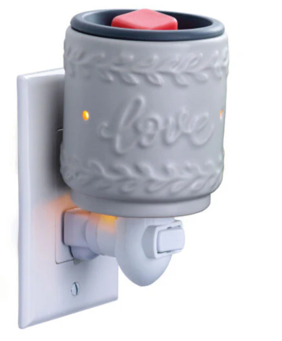 Plug In Warmers & Jumbled Joy Wax Melts, plug in wax warmers with fragrance melts in a decorative design.