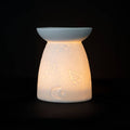 White Ceramic Constellation Tealight Wax Warmer featuring celestial design and warm glow.