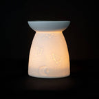 White Ceramic Constellation Tealight Wax Warmer featuring celestial design and warm glow.