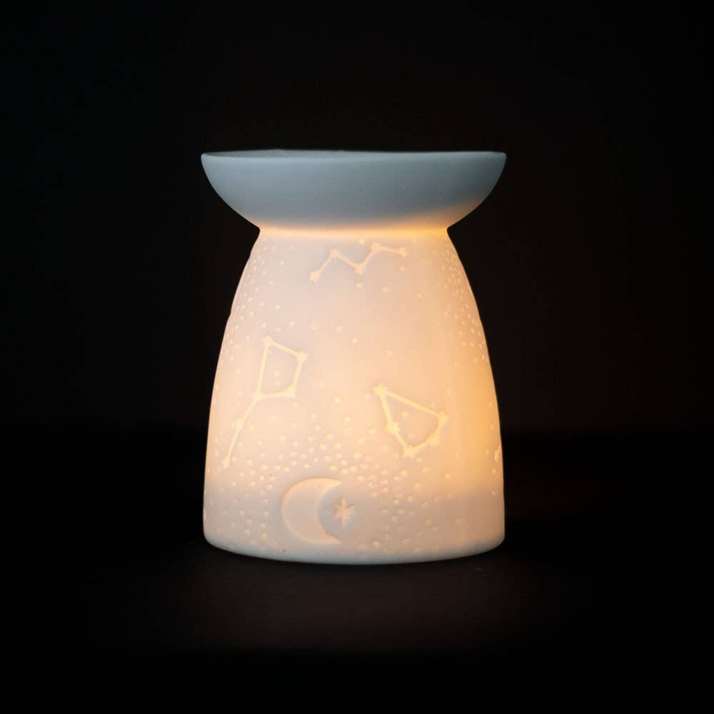 White Ceramic Constellation Tealight Wax Warmer featuring celestial design and warm glow.