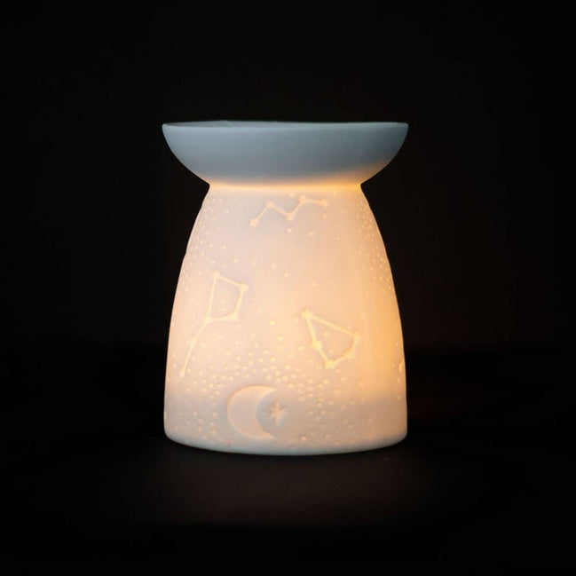 White Ceramic Constellation Tealight Wax Warmer featuring celestial design and warm glow.
