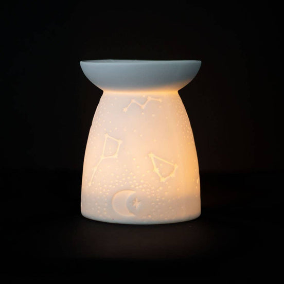 White Ceramic Constellation Tealight Wax Warmer featuring celestial design and warm glow.