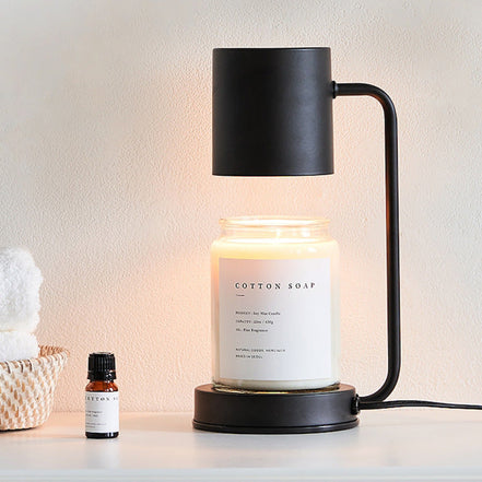 Modern dimmable candle warmer lamp featuring a sleek design with a lit jar candle.
