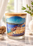 Aegean Islands Candle in a glass jar with wooden lid, featuring coastal scenery and natural decor elements.