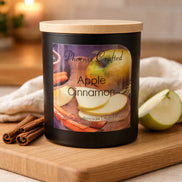Apple Cinnamon Candle in a stylish black jar with wooden lid, featuring apples and cinnamon sticks.