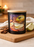 Apple Cinnamon Candle in a stylish black jar with wooden lid, featuring apples and cinnamon sticks.