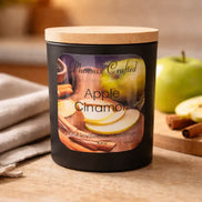 Matte black Apple Cinnamon candle jar with a light wood lid by Phoenix Crafted.
