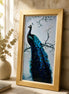 Azure Crest Peacock Diamond Painting displayed in a gold frame against a stone wall.