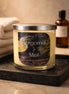 Phoenix Crafted Bergamot & Mint candle — pale yellow wax in clear glass jar with silver lid and black label, set on a wet black tray.