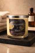 Bergamot & Mint Candle in a glass jar on a tray with towels, reflecting a fresh and clean atmosphere.