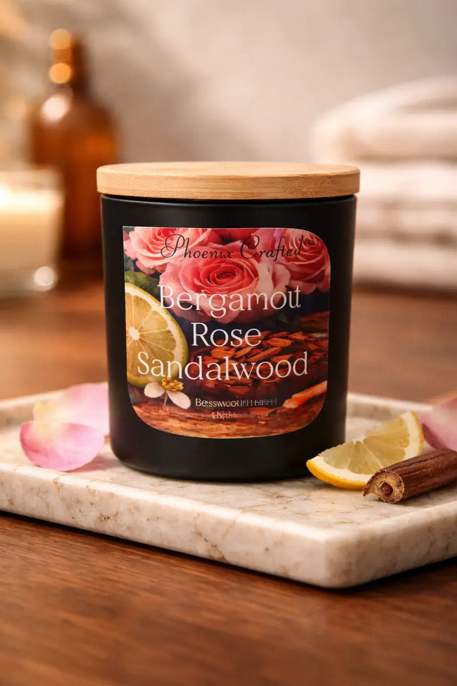 Bergamot Rose & Sandalwood Candle on a marble tray with lemon and rose petals, creating an elegant floral-wood ambiance.