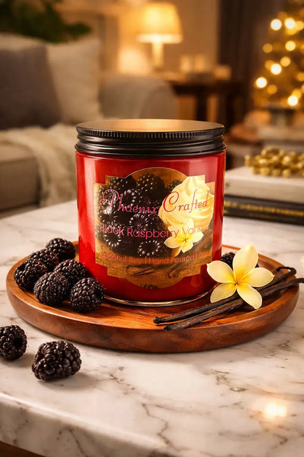 Black Raspberry Vanilla Candle on a wooden tray surrounded by black raspberries and vanilla flowers.