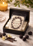 Black Raspberry Vanilla Wax Melts in a stylish box with a warm ambiance, surrounded by vanilla and blackberries.