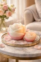 Decorative Bohemian Rose Candles displayed on a marble table, emitting soft smoke and surrounded by rose petals.