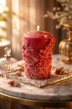 Decorative Bohemian Rose Candles on a marble table, featuring a textured rose-scented candle glowing warmly.