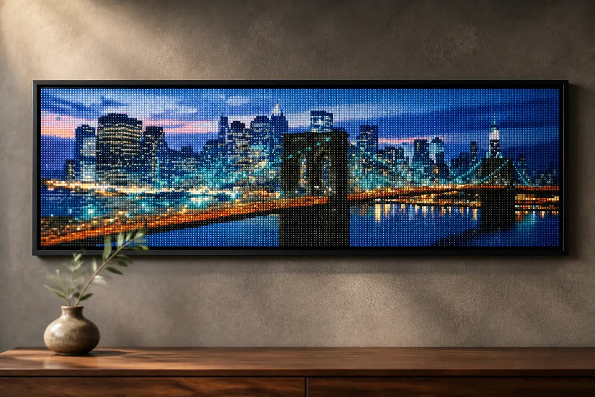 Brooklyn Bridge Nights finished cityscape diamond artwork shown in a wide frame mockup; artwork is sold unframed.