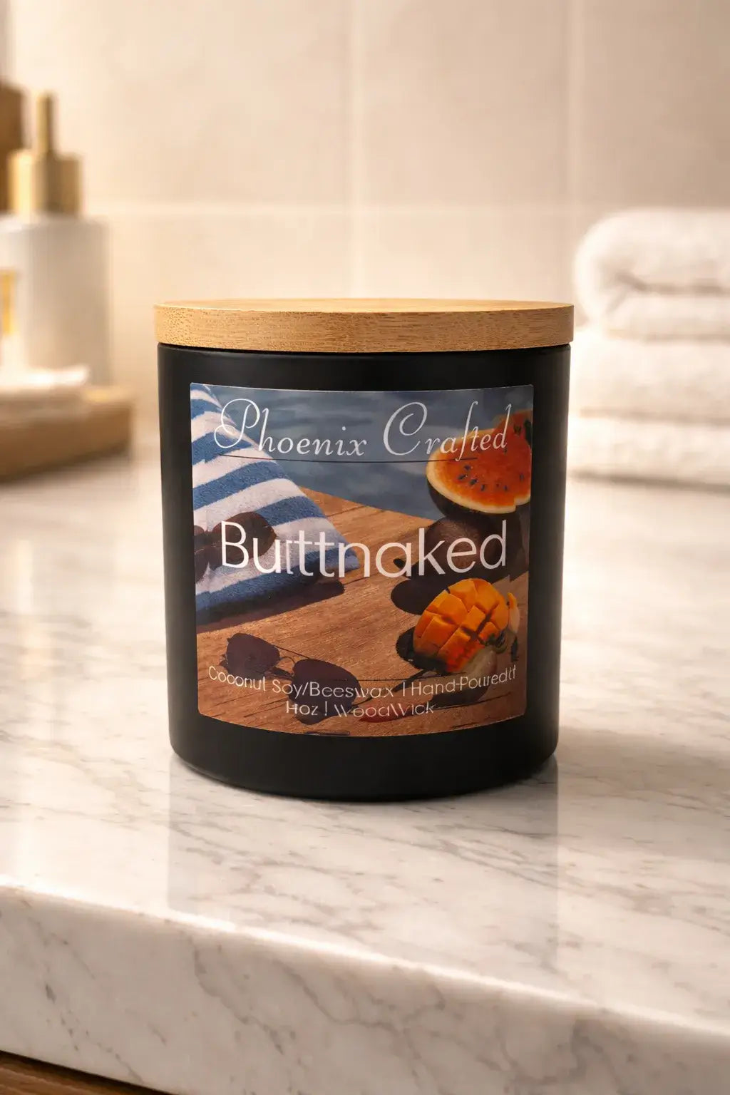 Butt Naked candle in a matte black jar with a wood lid on a light marble counter.