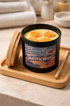 Buttnaked Candle with floral design, placed on a wooden tray, perfect for uplifting home fragrance.