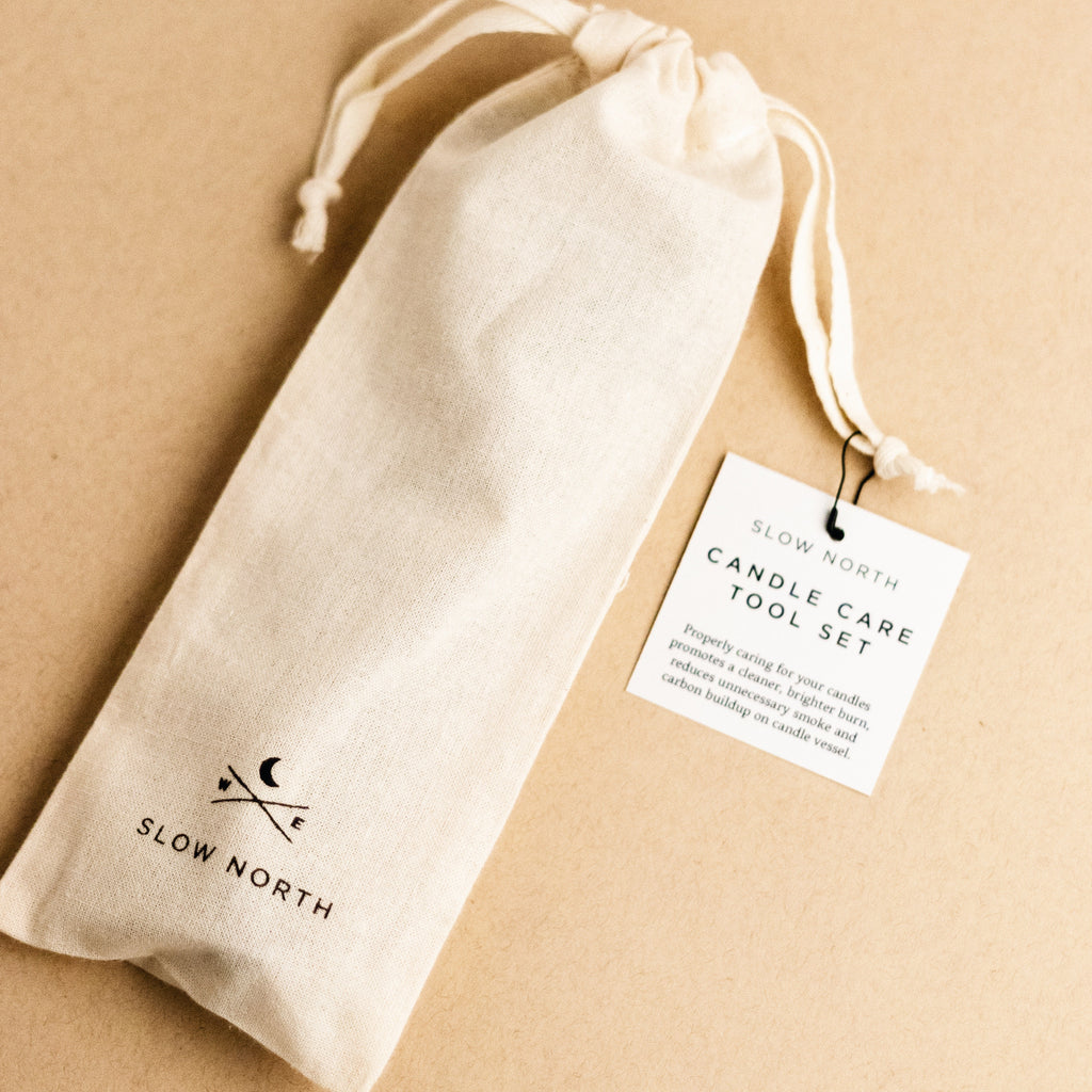 Candle care tool set packaged in a natural fabric pouch, perfect for candle maintenance and enhancing burn quality.