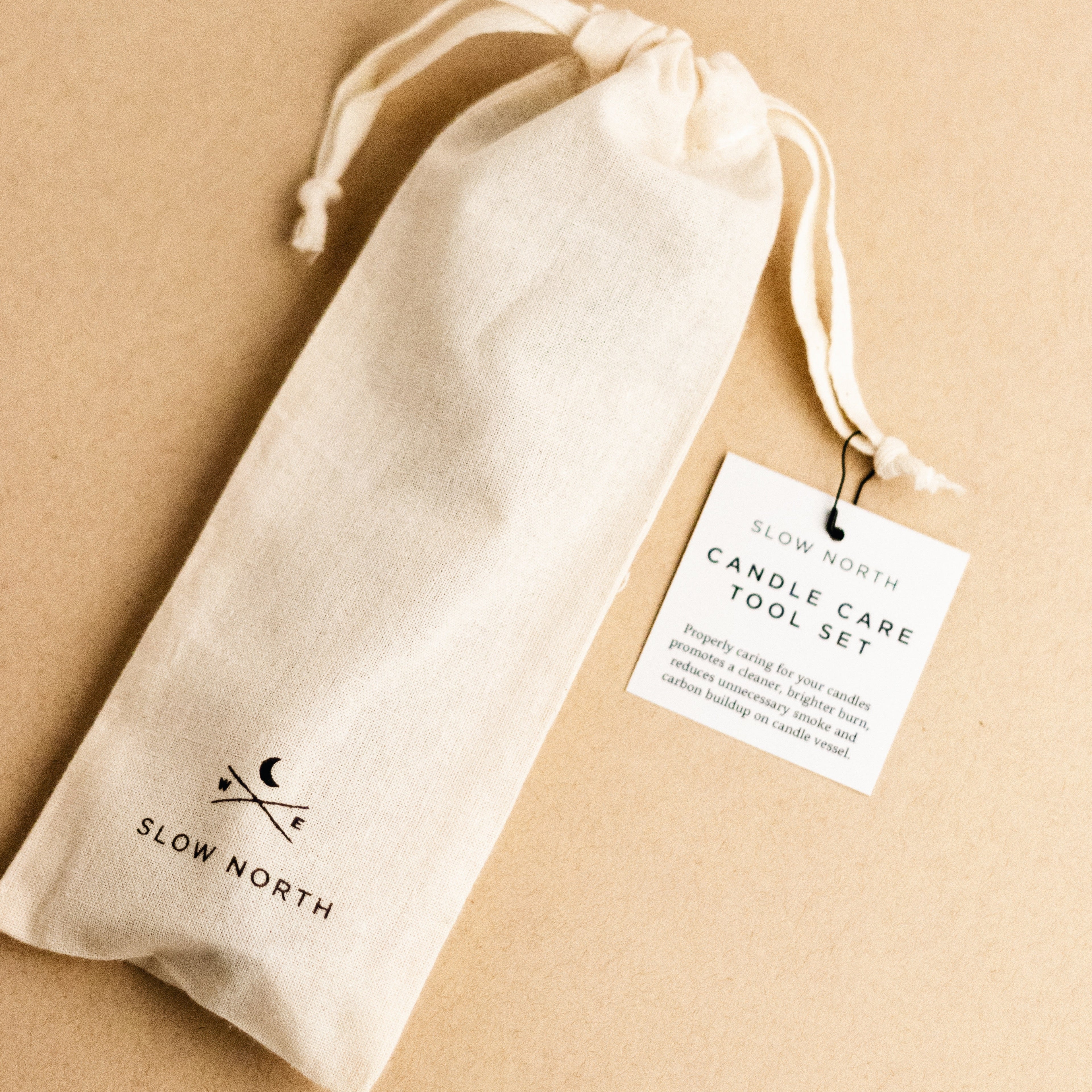 Candle care tool set packaged in a natural fabric pouch, perfect for candle maintenance and enhancing burn quality.