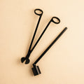 Candle care tool set featuring wick trimmer, snuffer, and dipper for optimal candle maintenance.